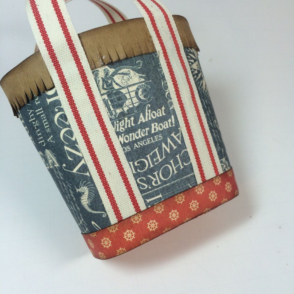 Adhere the accent strip you cut earlier around the base of the tote. This covers the raw edges of the ribbon nicely.