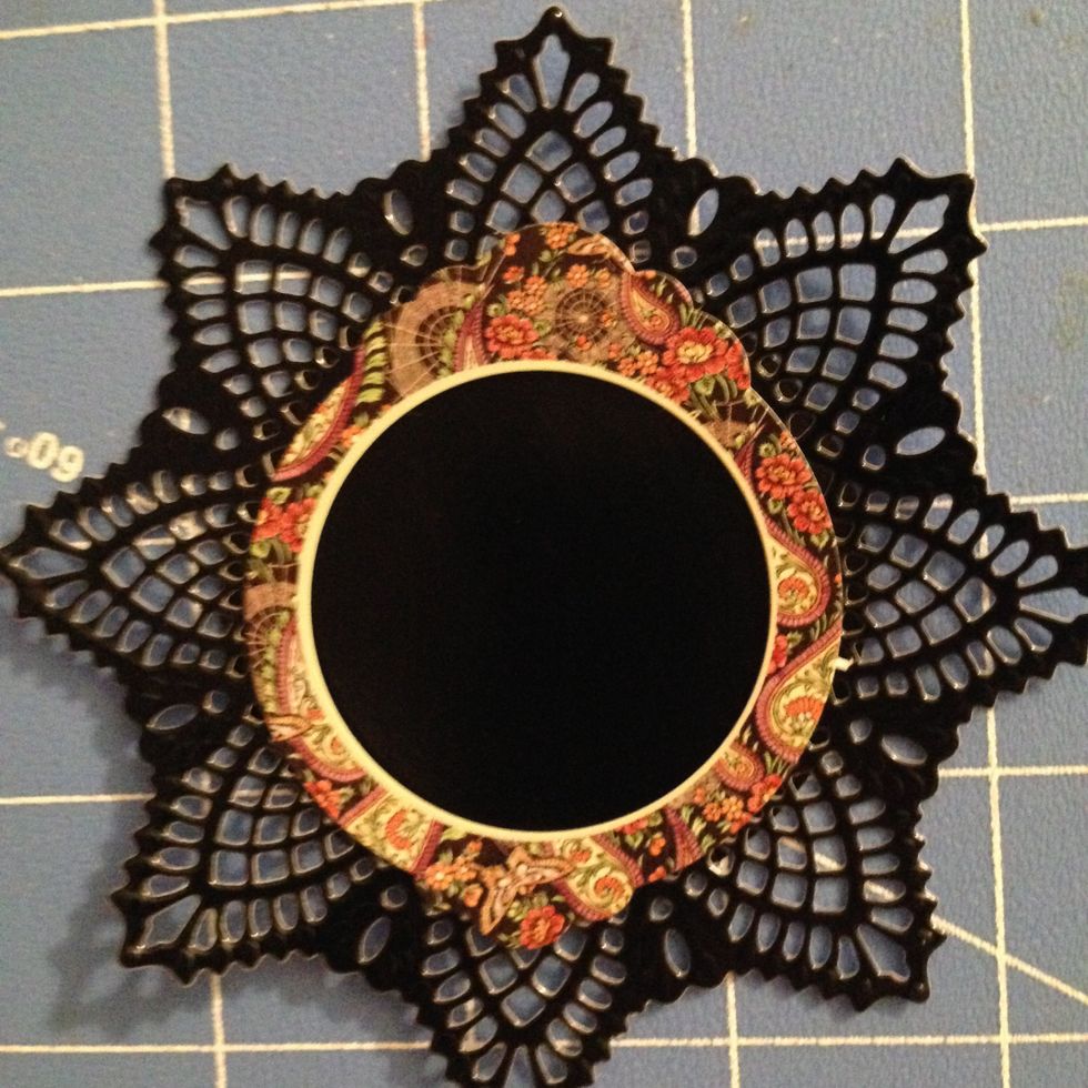 Adhere the black circle to the back of the doily and sticker.