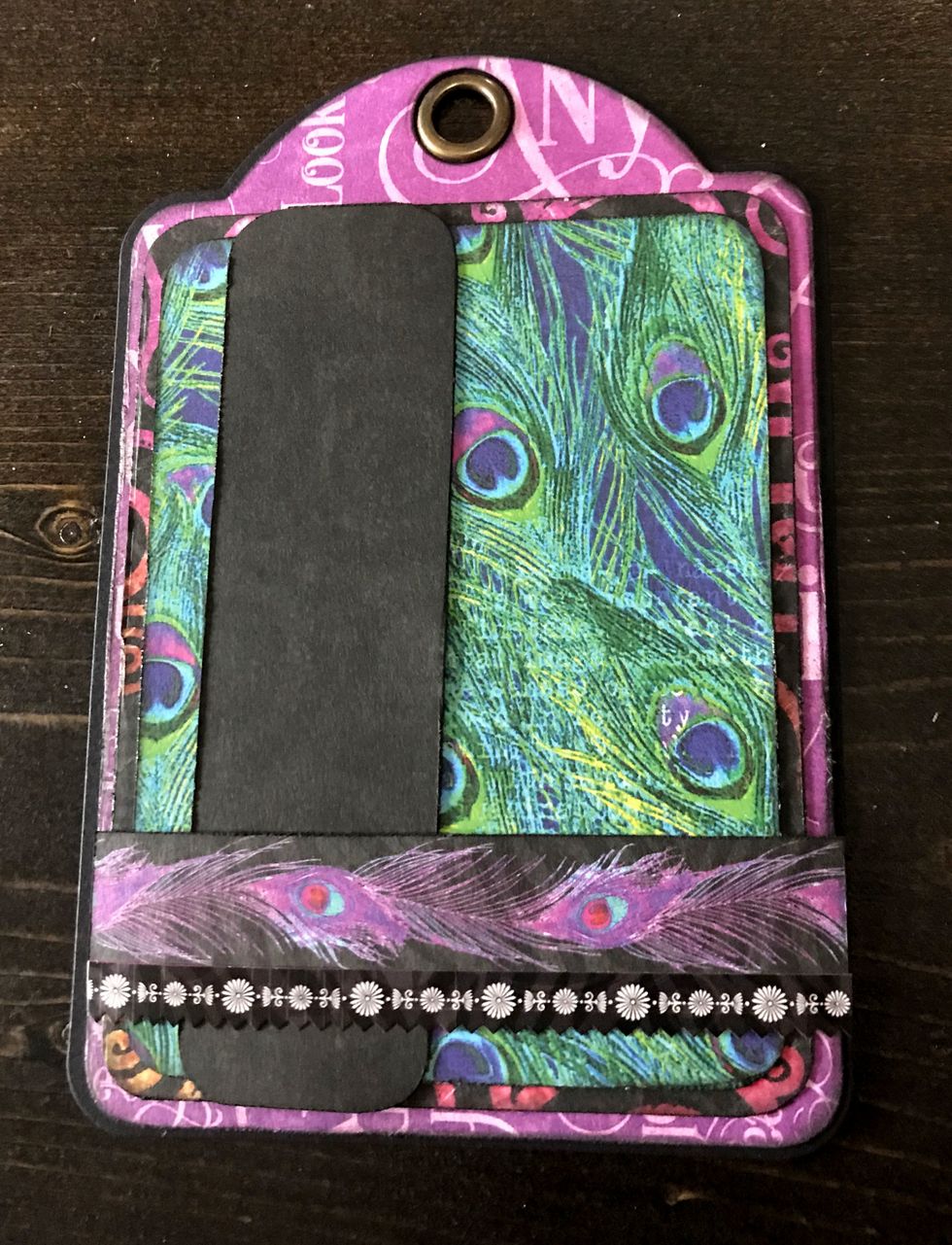 Adhere the black strip 1/2" from left of tag. Adhere border strip 3/4" from the bottom of the tag. Cut a border strip from the stickers down to 4". Adhere border slightly overtop of the border.