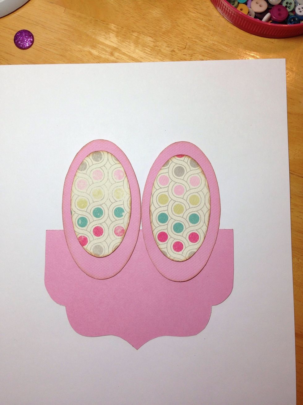 Adhere the bunny ears to the back of one of the brackets.