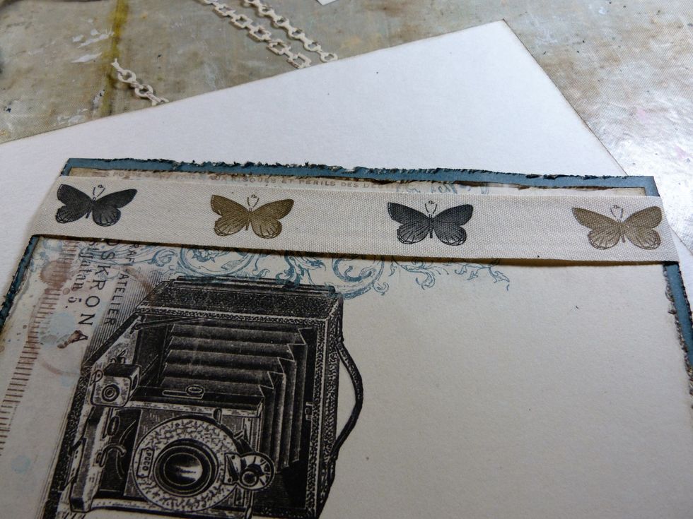 Adhere the butterfly ribbon the  left hand side of the card tucking the edges underneath.