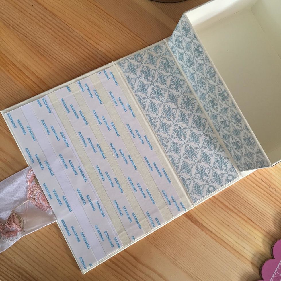 Adhere the card on the back cover of the book box.