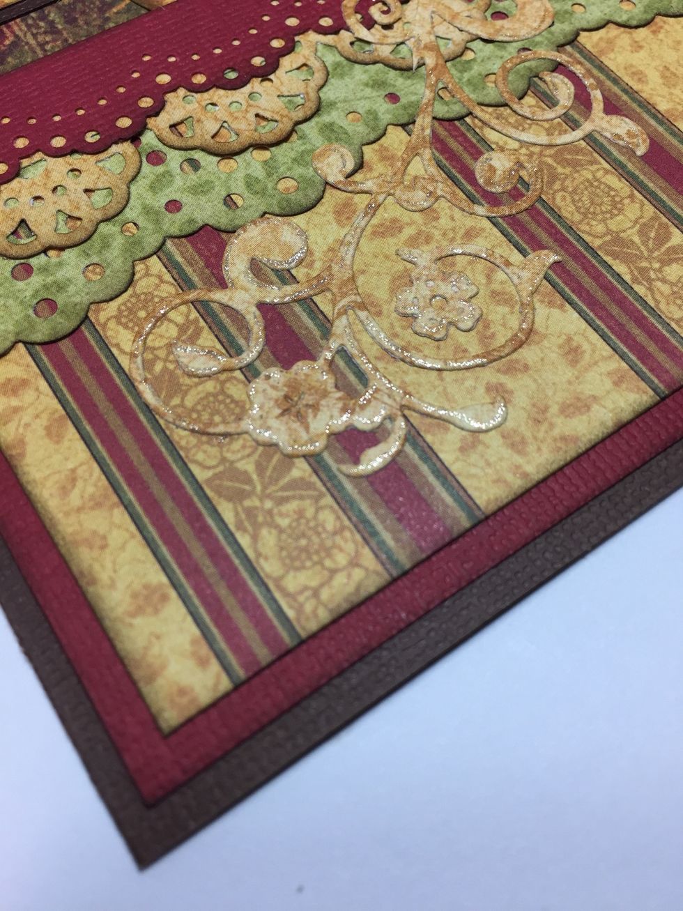 Adhere the die-cut flourish next. To make it "pop" you can add a bit of sparkle with a Gelly Roll Stardust pen. This die is called "Fantastic Flourish One" by Spellbinders.