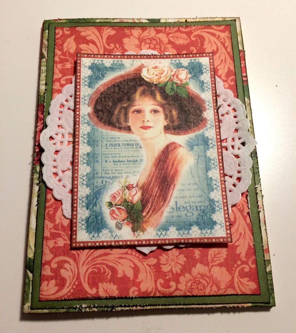 Adhere the doily in the middle of the red damask paper. Foam square the lady to the middle of the doily.