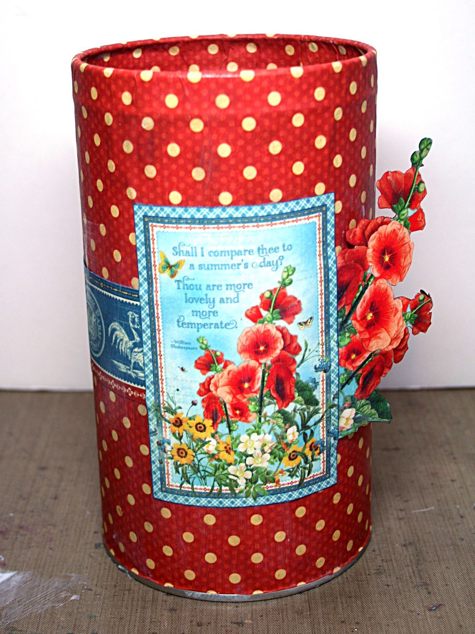 Adhere the flowers and cut-apart to the can over the gap in the strip and allowing the fussy cut flowers to stand free from the can.
