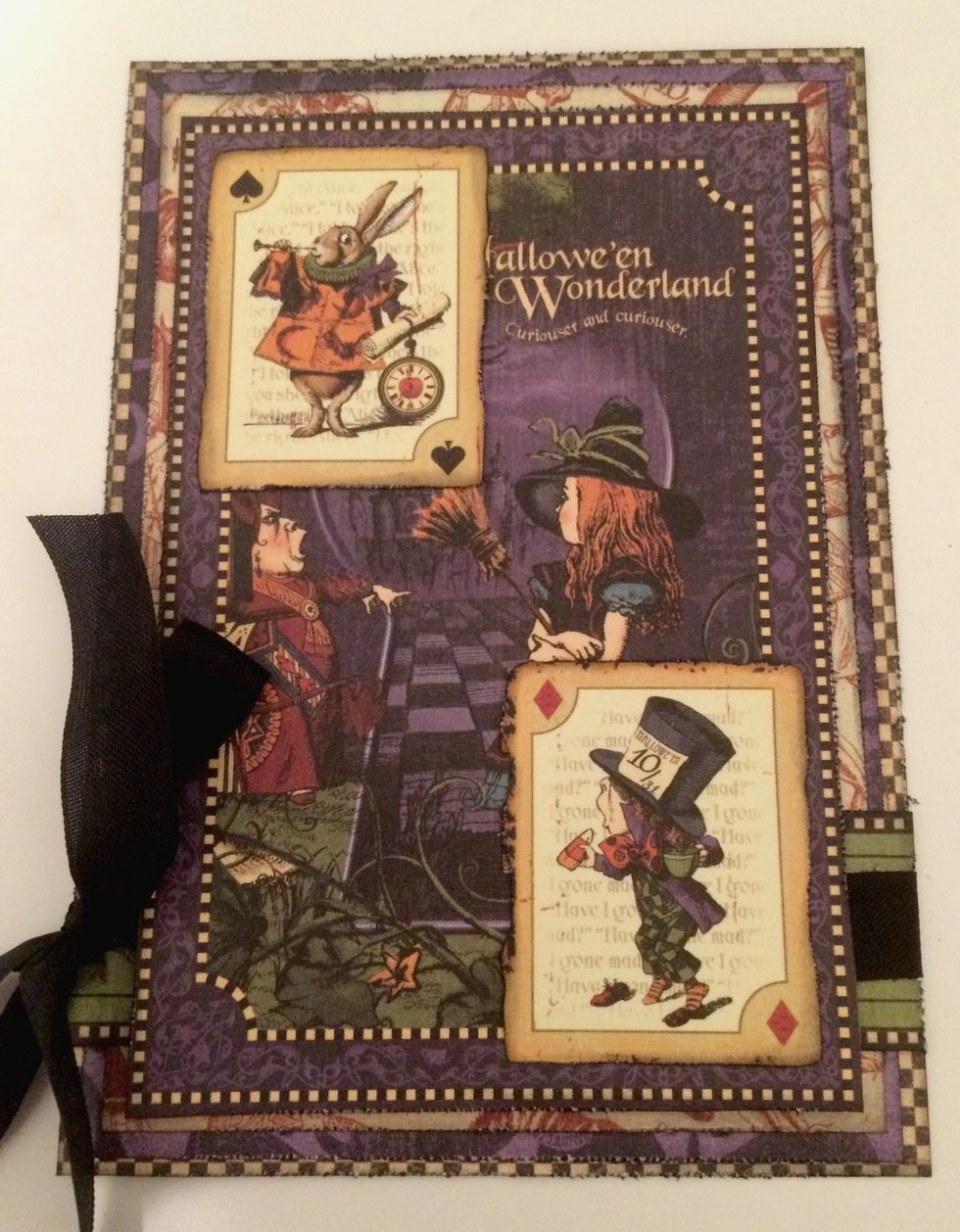 Adhere the full Hallowe'en in Wonderland paper to the middle of red & cream paper. Adhere one playing card to the top left corner and adhere a second playing card to the bottom right corner.