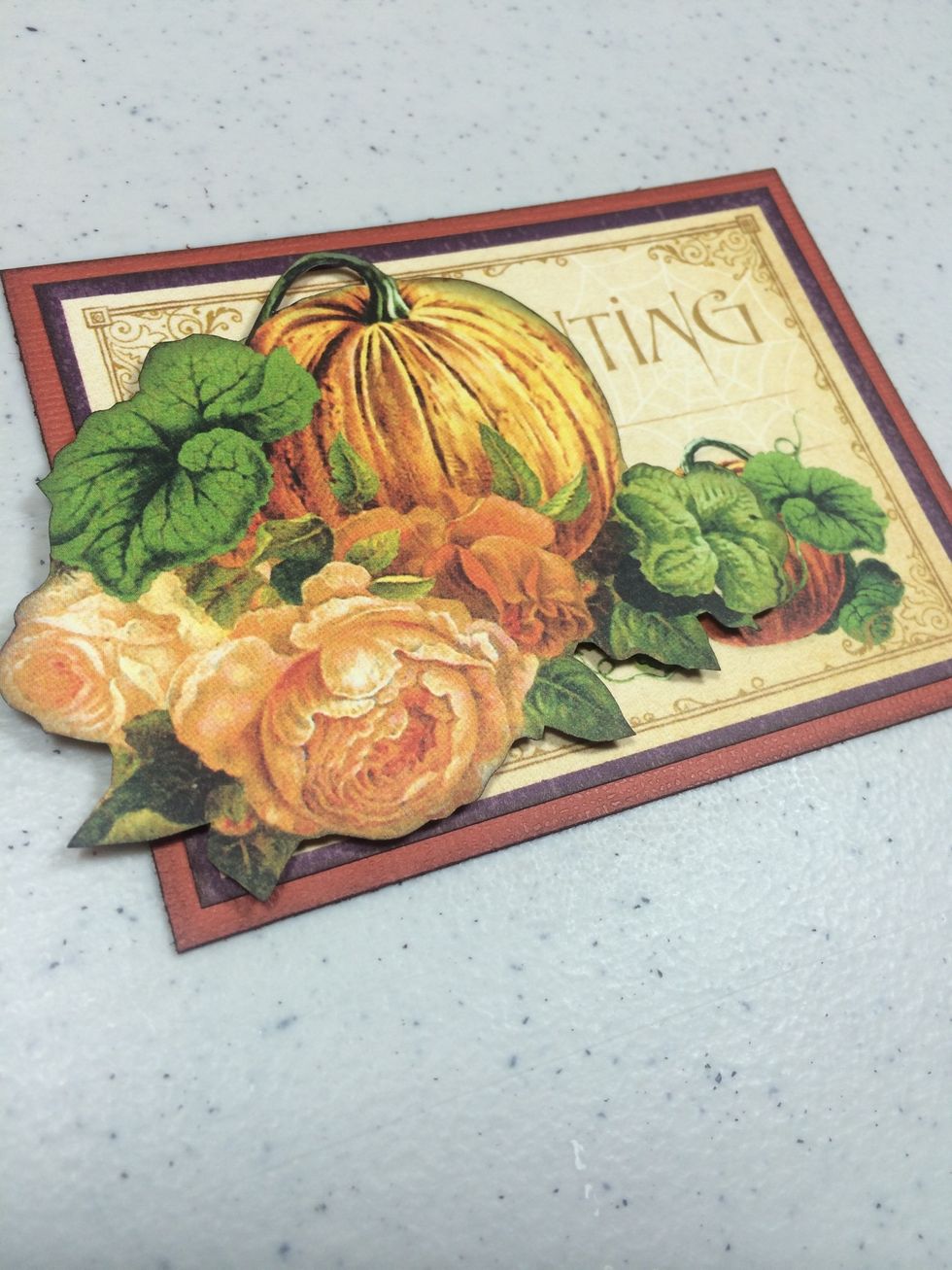 Adhere the fussy cut image to the unit from before. This will mostly cover the word Enchanting, which is what we want.