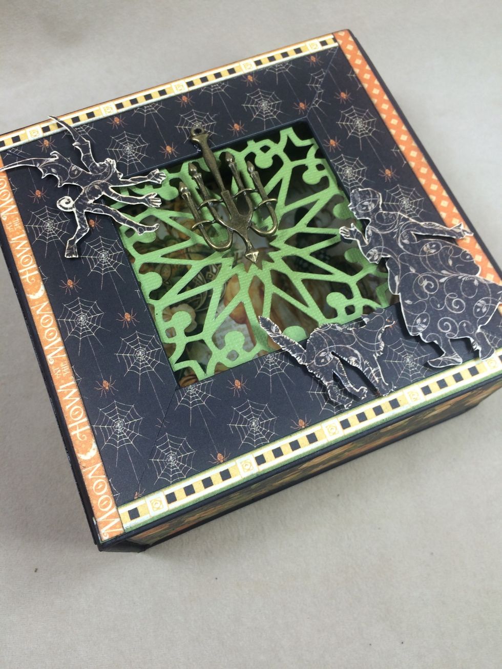 Adhere the fussy cut images with dimensional foam tape to the box front.