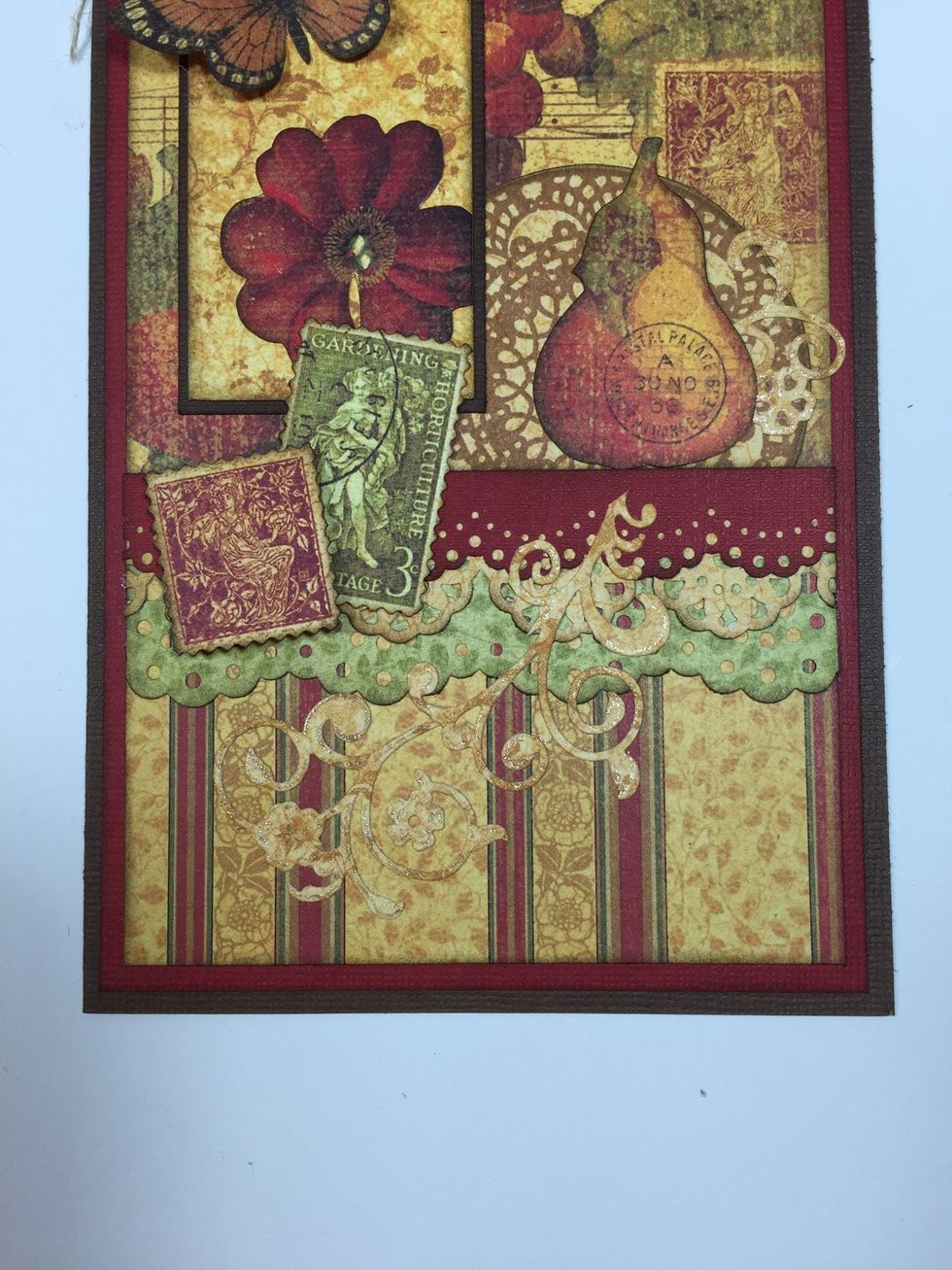 Adhere the fussy-cut pear, and layer the two postage stamps. To add dimension and interest, use foam squares to pop up one of them.