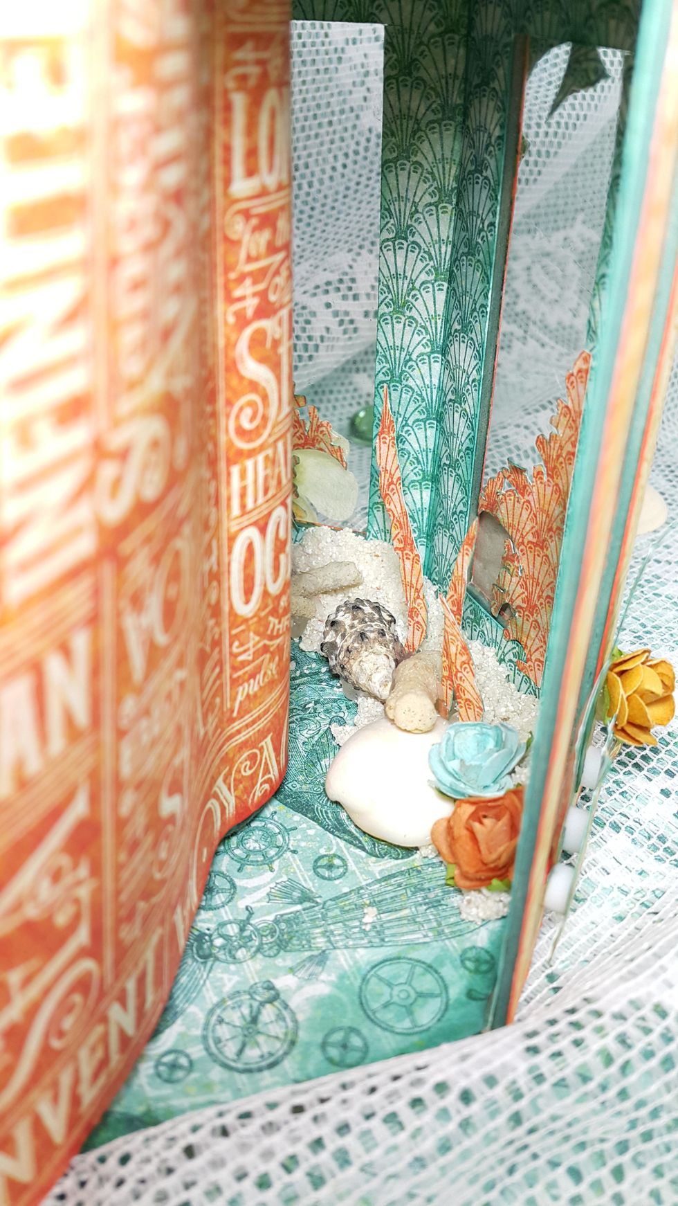 Adhere the fussy cuttings in between the stones and shells will make it easier to stay upright.