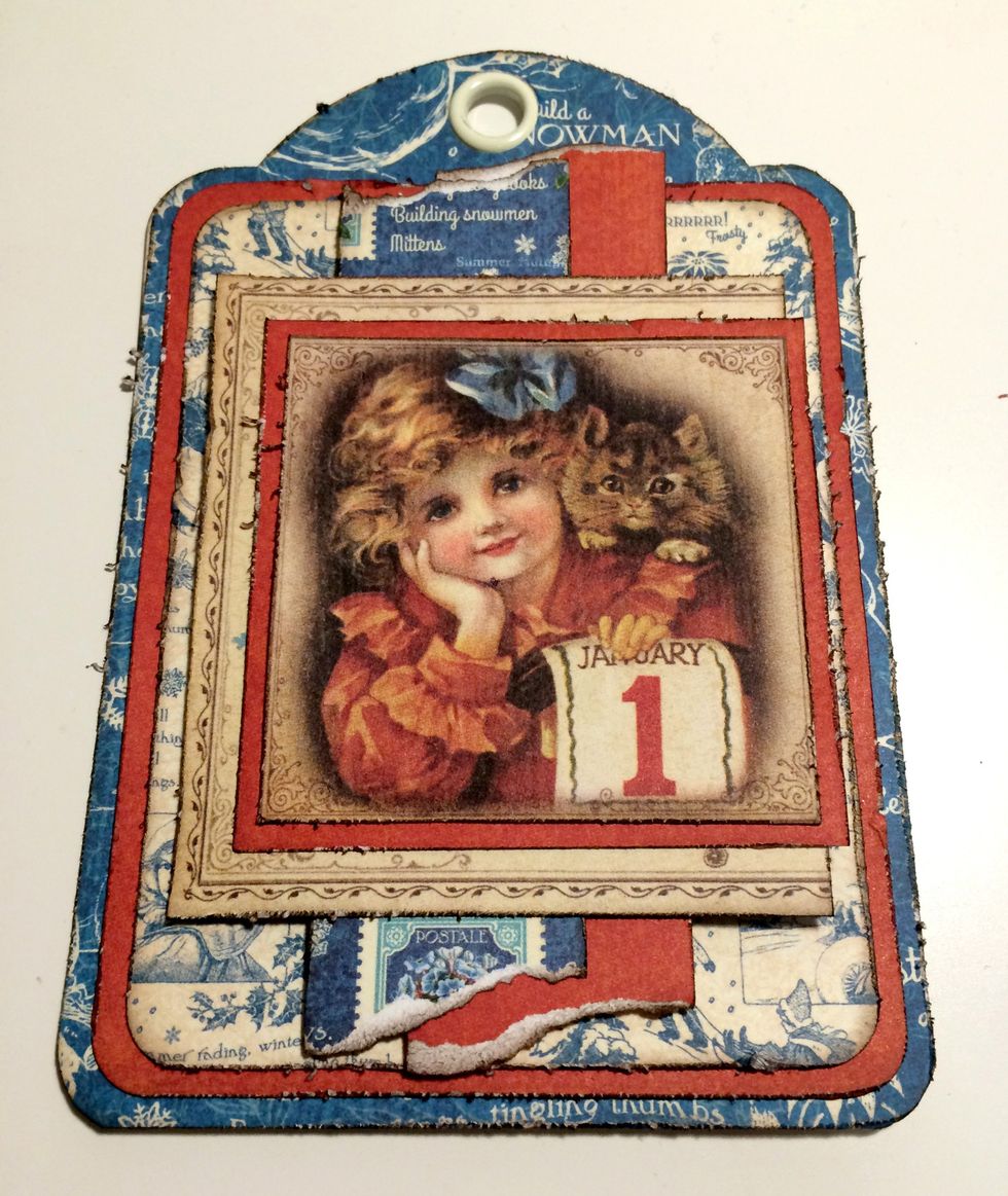 Adhere the girl with cat to the last piece of red paper. Adhere the red paper 1/4" from the left of the postcard.