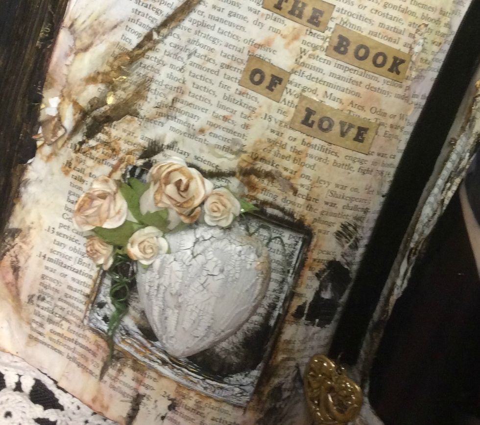 Adhere the heart in its space and then glue assorted flowers around it. I misted them with water then applied Vintage Photo DI to the edges.