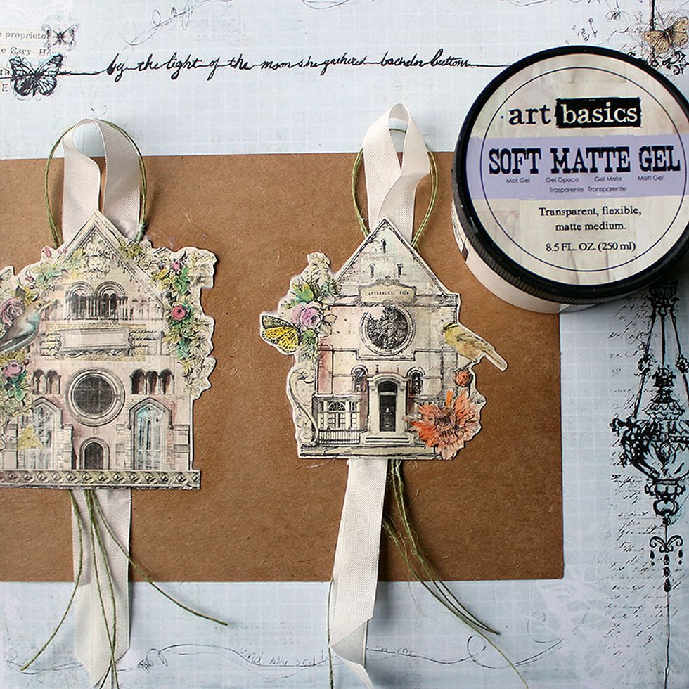 Adhere the houses to stencil packaging (or other stiff cardstock) with Soft Matte Gel. Add ribbon and jute trim between the two paper layers as shown.