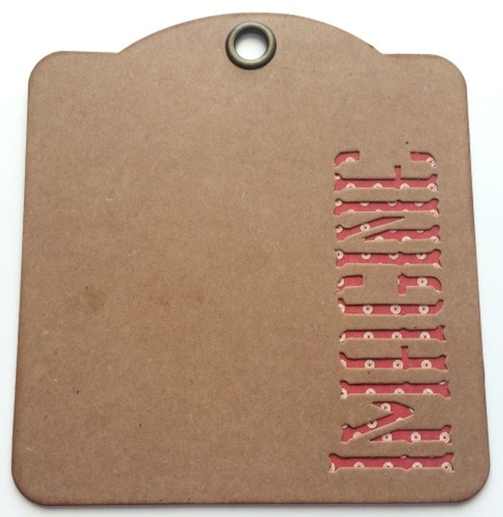 Adhere the kraft Imagine tag over top of the the red and white dot paper tag.