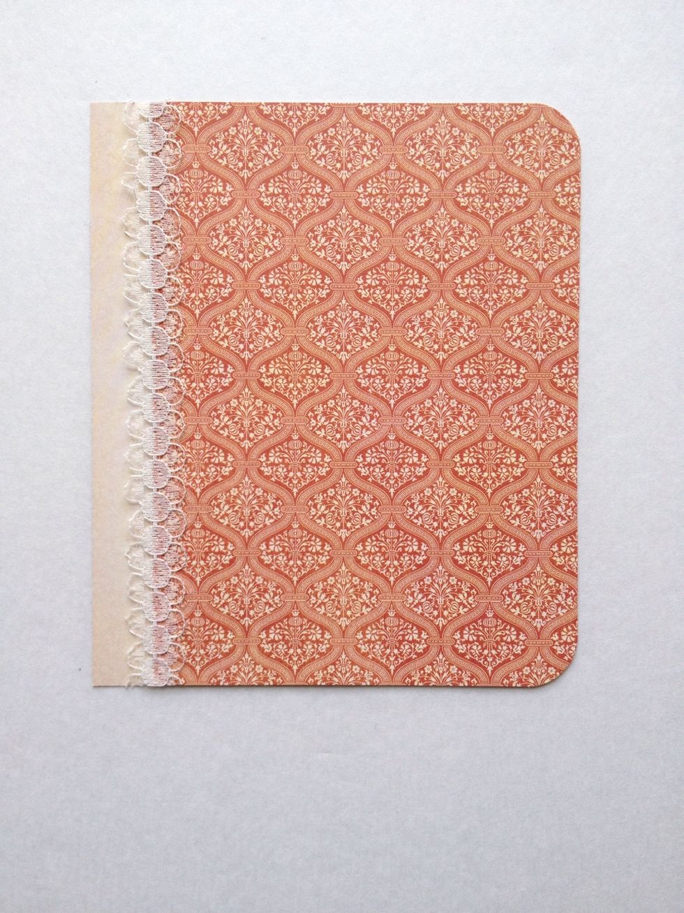 Adhere the lace ribbon and use a corner rounder on the upper and lower right corners.