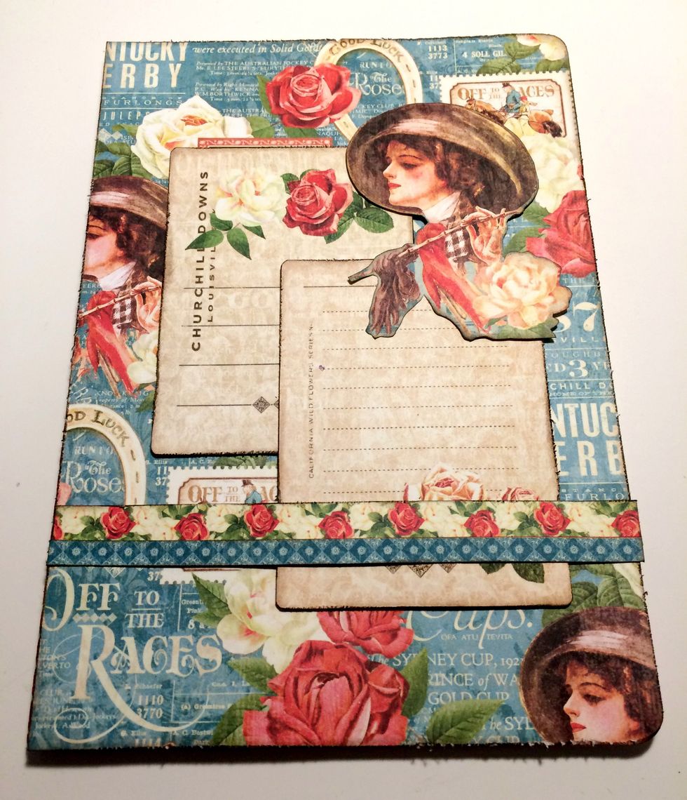 Adhere the lady in the top right corner overtop of the two journaling cards. Adhere the rose border 1 3/4" from the bottom. Adhere the blue diamond border slightly overtop of the rose border.