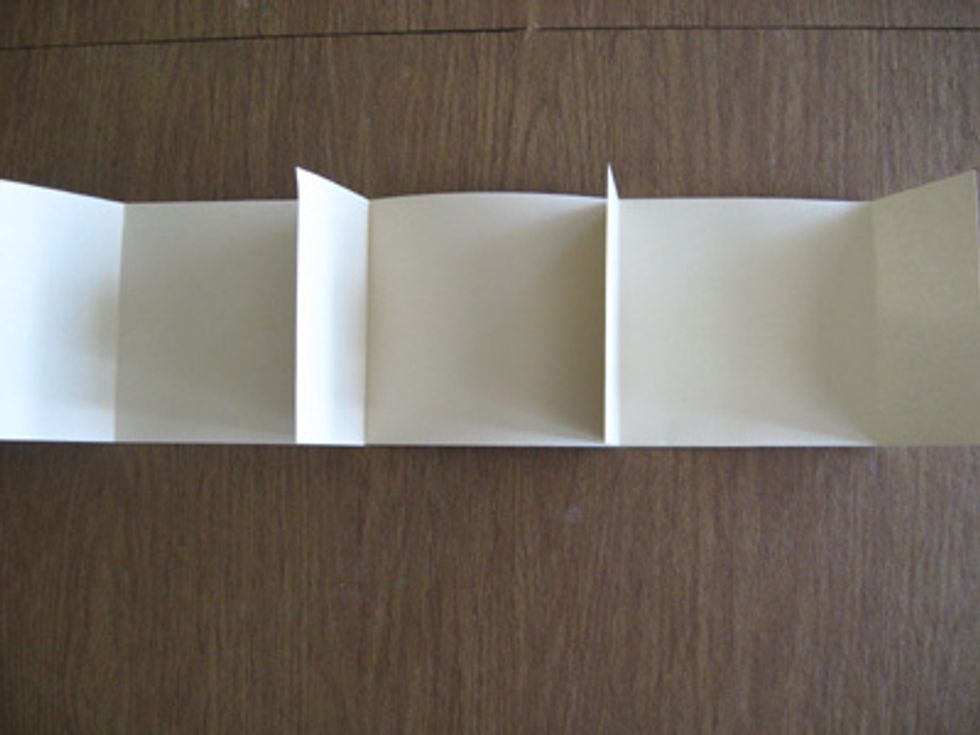 Adhere the other two pieces of 5-3/4   by 12 inch pieces of cardstock to the one with the double sided tape so that it looks like the photo above. Fold the flaps in.  This is the inside of your album.