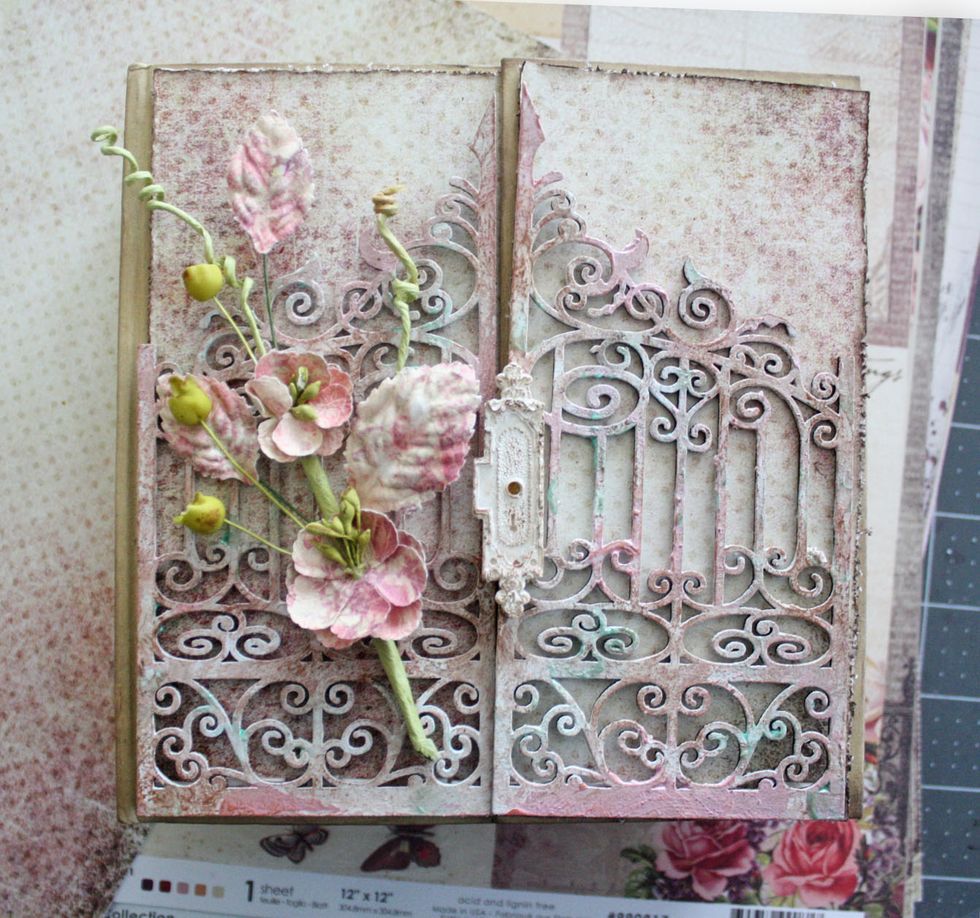 Adhere the pattern paper to the cover and layer the gates. Add the lock to the center only gluing on the right side panel.