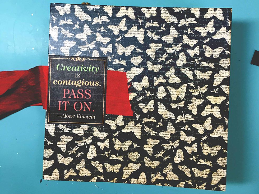 Adhere the pictured cut-apart over the ribbon on the back of the mini using matte medium.