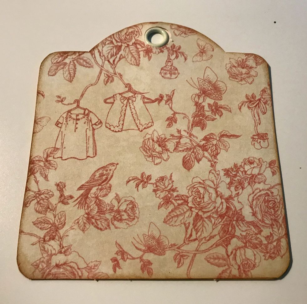 Adhere the pink floral paper tag to the ivory tag.