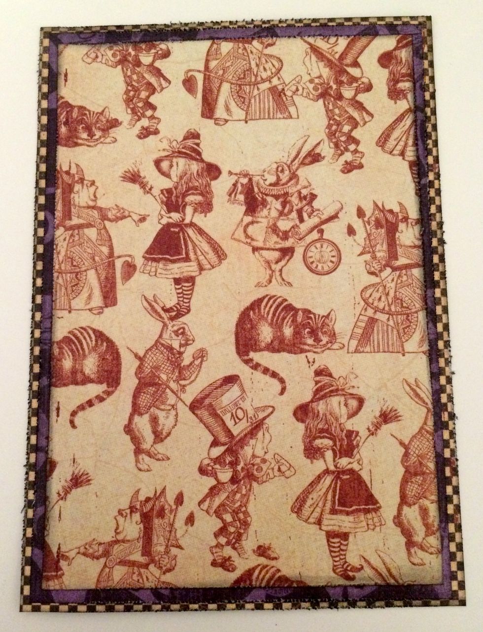 Adhere the red and cream patterned paper to the mad hatter patterned paper. Adhere the mad hatter patterned paper to the checker patterned paper.