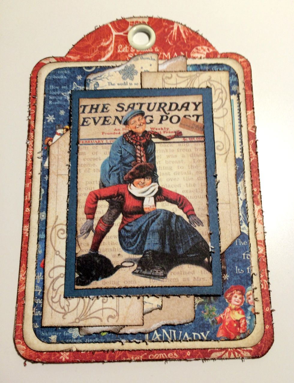 Adhere the Saturday Post image to the blue paper. Adhere the blue paper to the middle of the two tags.