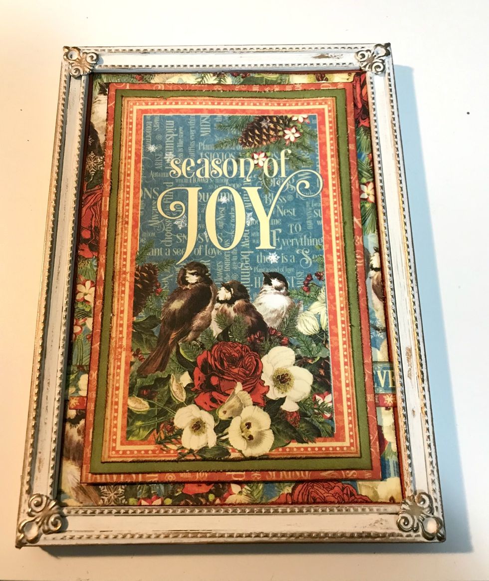 Adhere the Season of Joy layered paper to the inside of the frame.