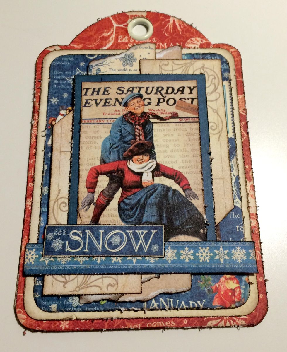 Adhere the snowflake border 1 3/4" from the bottom of the tag. Adhere the Let It Snow cut apart 3/8" from the left of the tag.