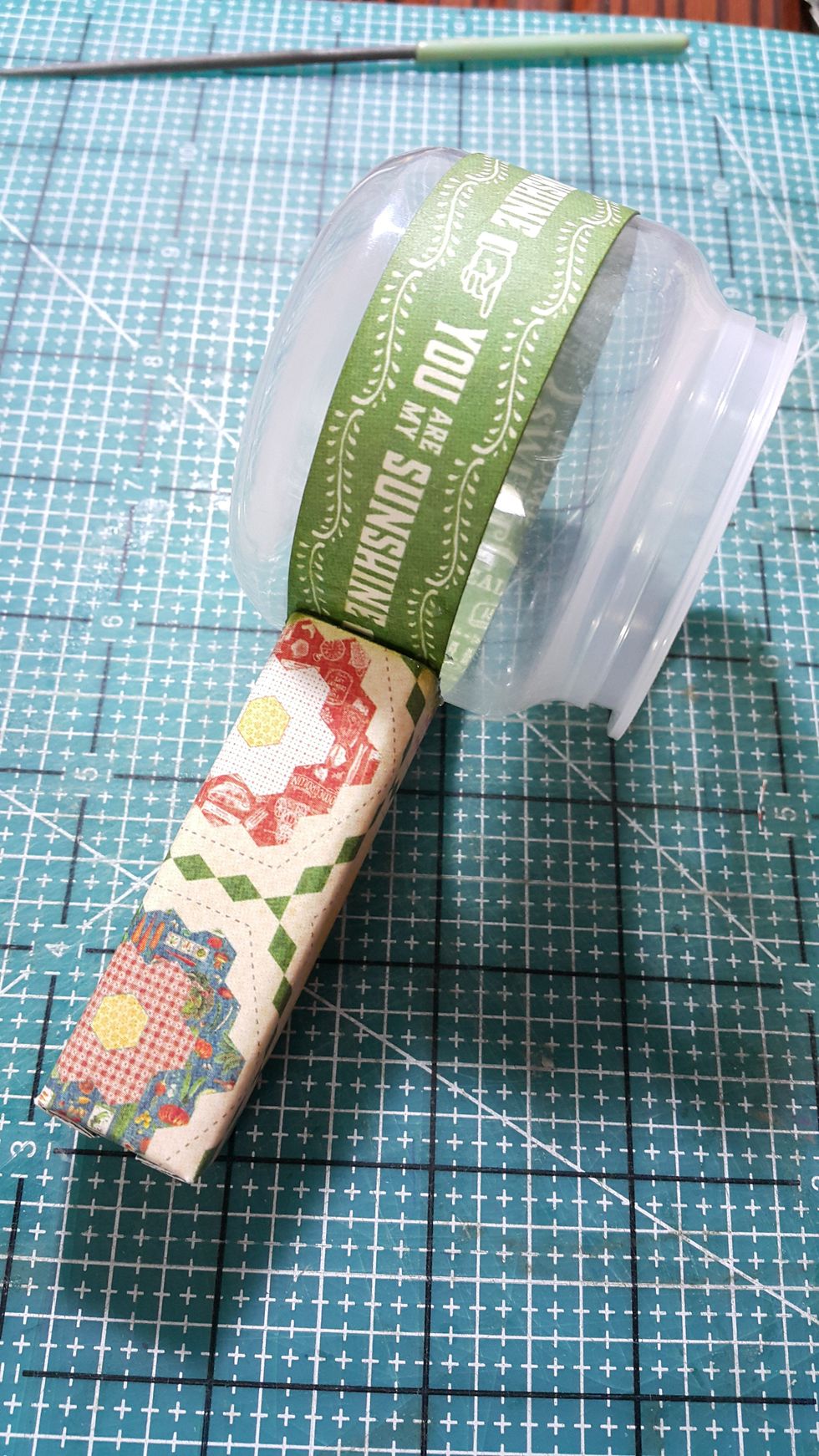 Adhere the upcycle yogurt bottle on the stand with super strong glue