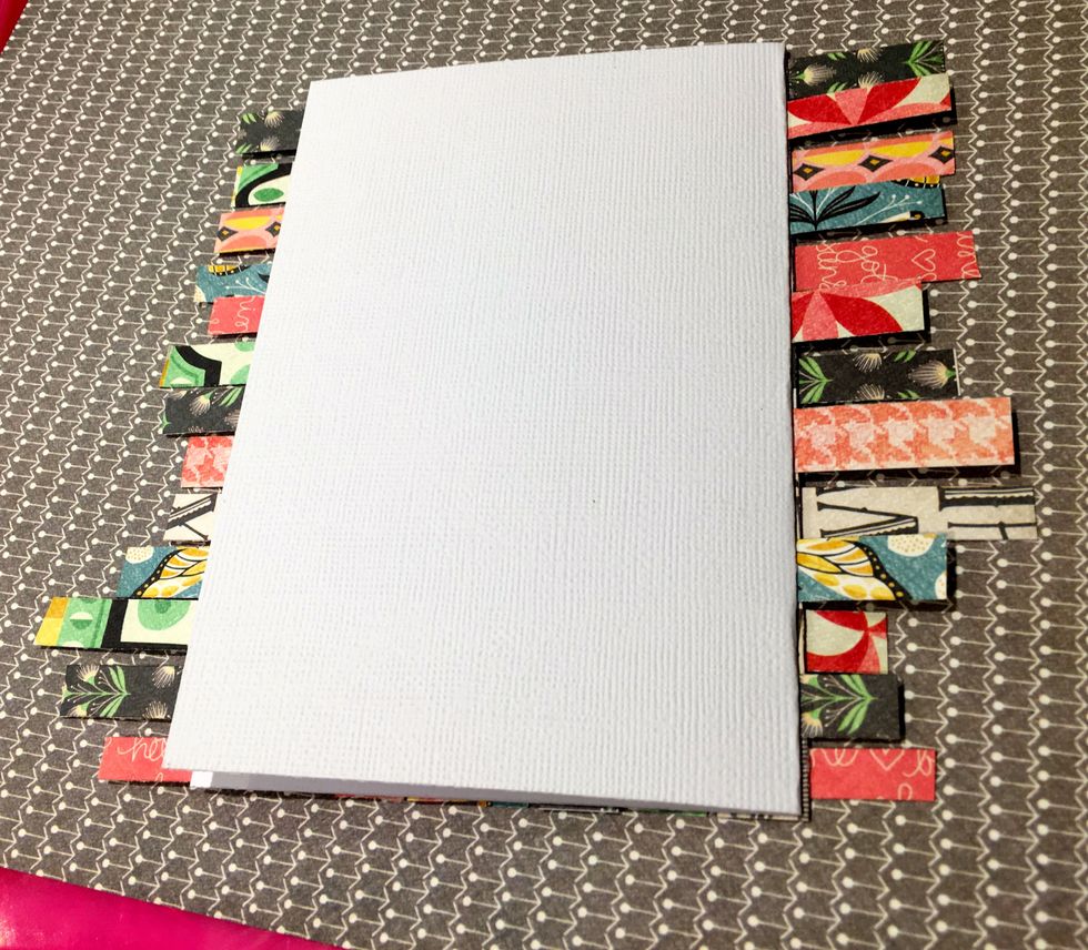 Adhere the weaved paper to the front of the card. Line it up so all the edges line up with the base of the card, The horizontal strips will hang over on both sides and need to be trimmed down.