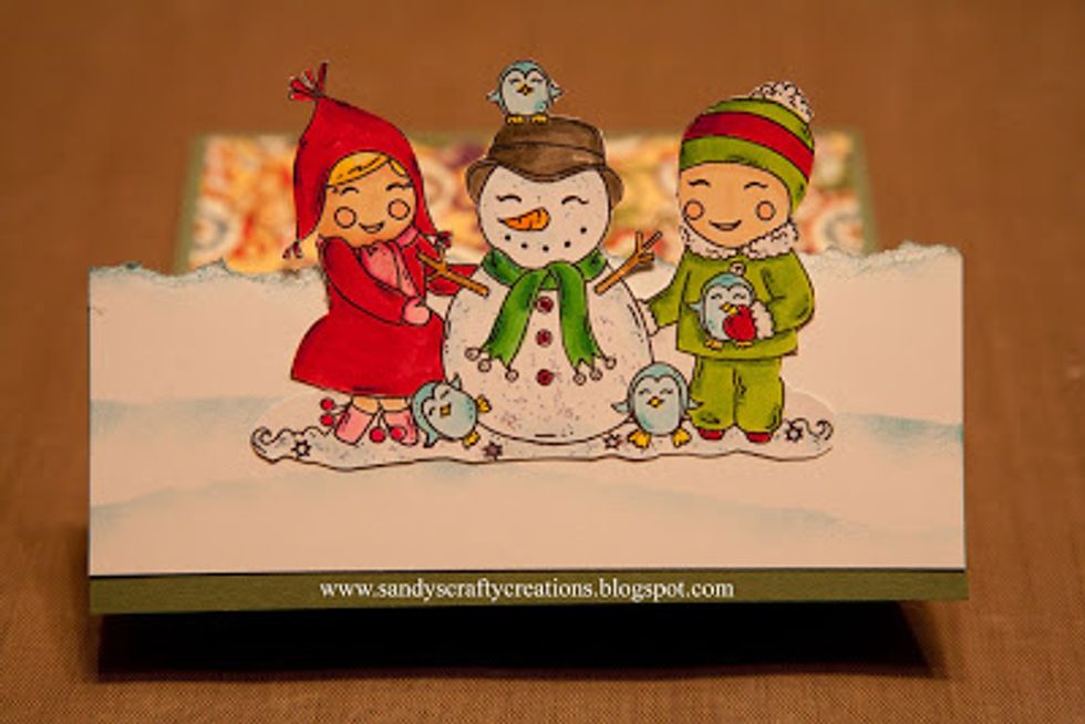 Adhere the white snow bank cardstock to the front of the card and then your image as shown