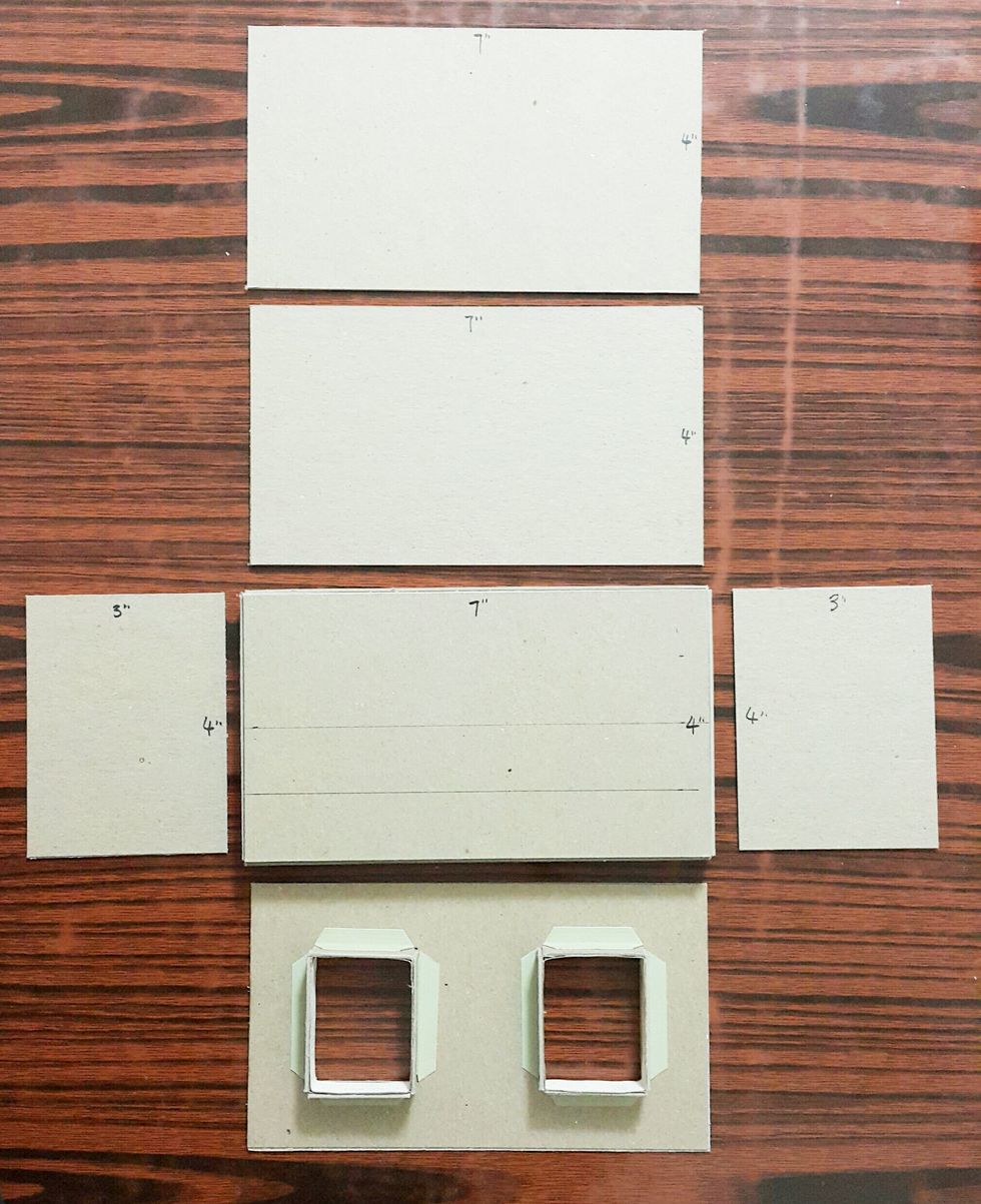Adhere the windows onto the shop front, and cut chipboard the for the shop body as shown. Mark 1inch and 2inch on the shop base.