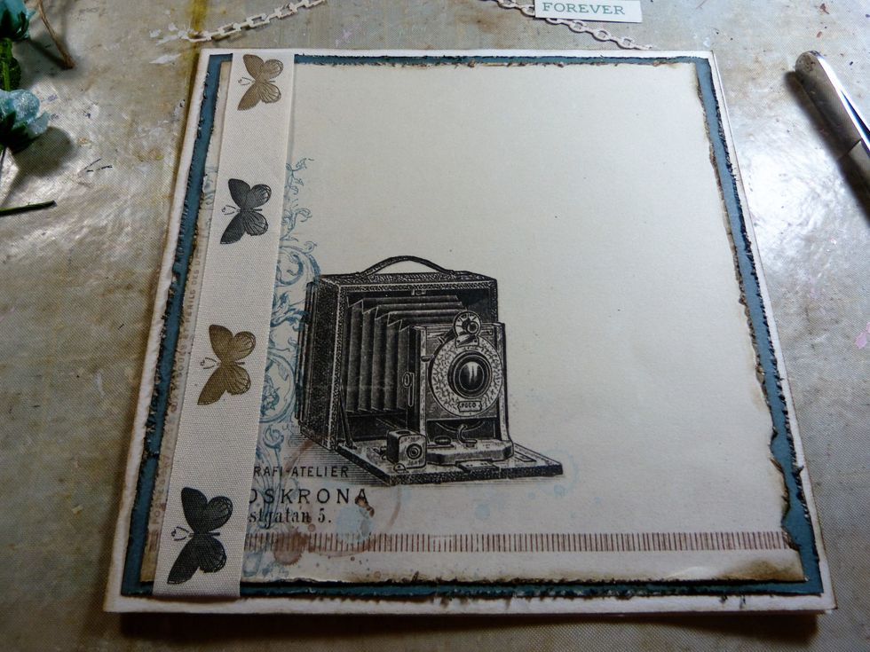 Adhere these papers to the card. Ink the edges of the card with Frayed Burlap.