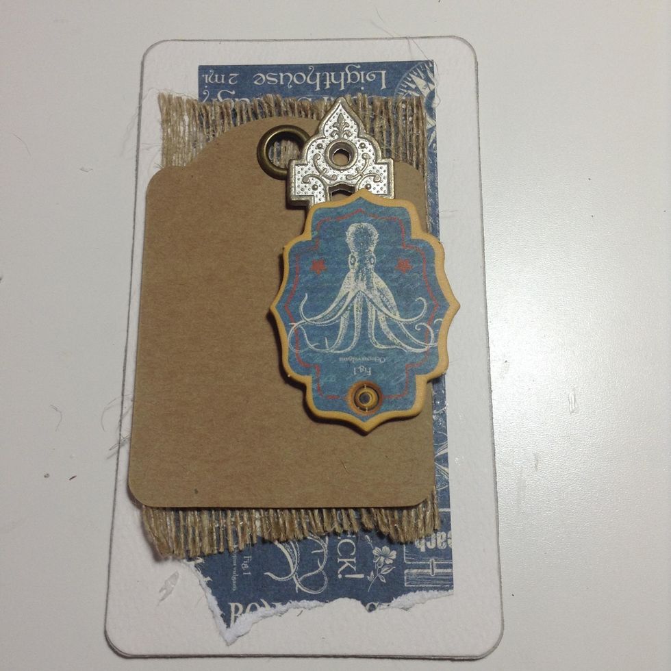 Adhere these to the cover as shown. I use strong glue when adhering metal embellishments.