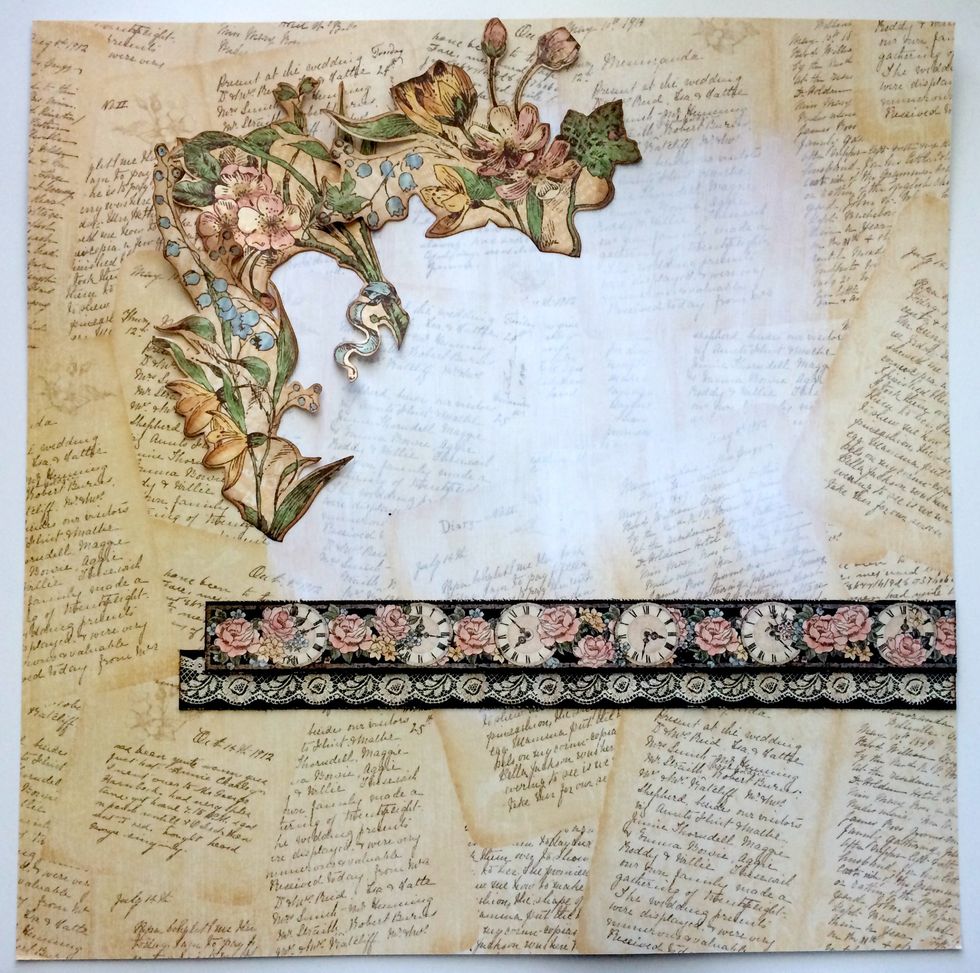 Adhere three of the floral bunches to the top left hand corner.