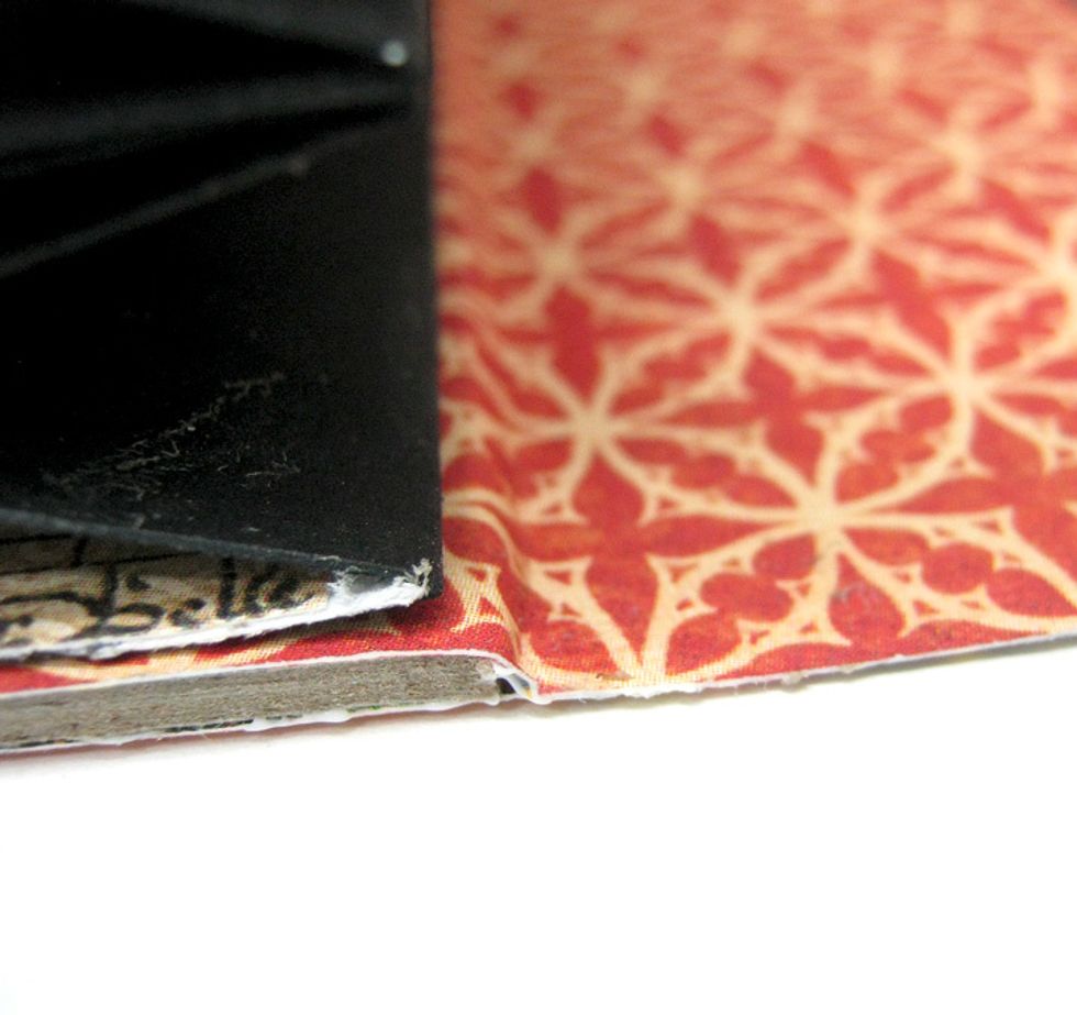 Adhere top and bottom paper together and burnish with bone folder to create the fold for the cover to close.