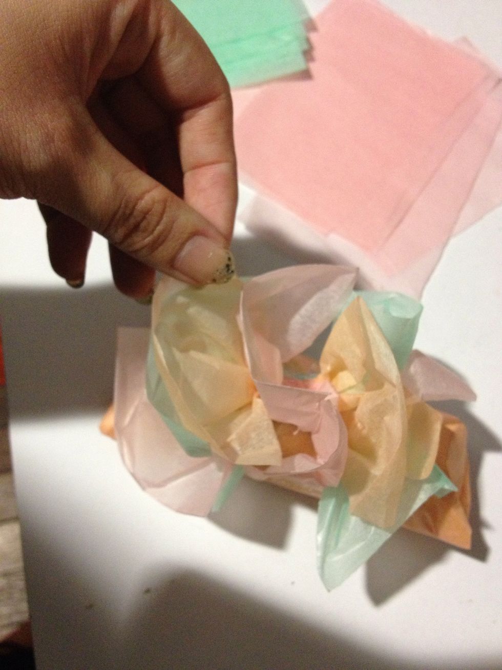 Adjust the paper to a desire shape to create a flower like, try to cover the tape too