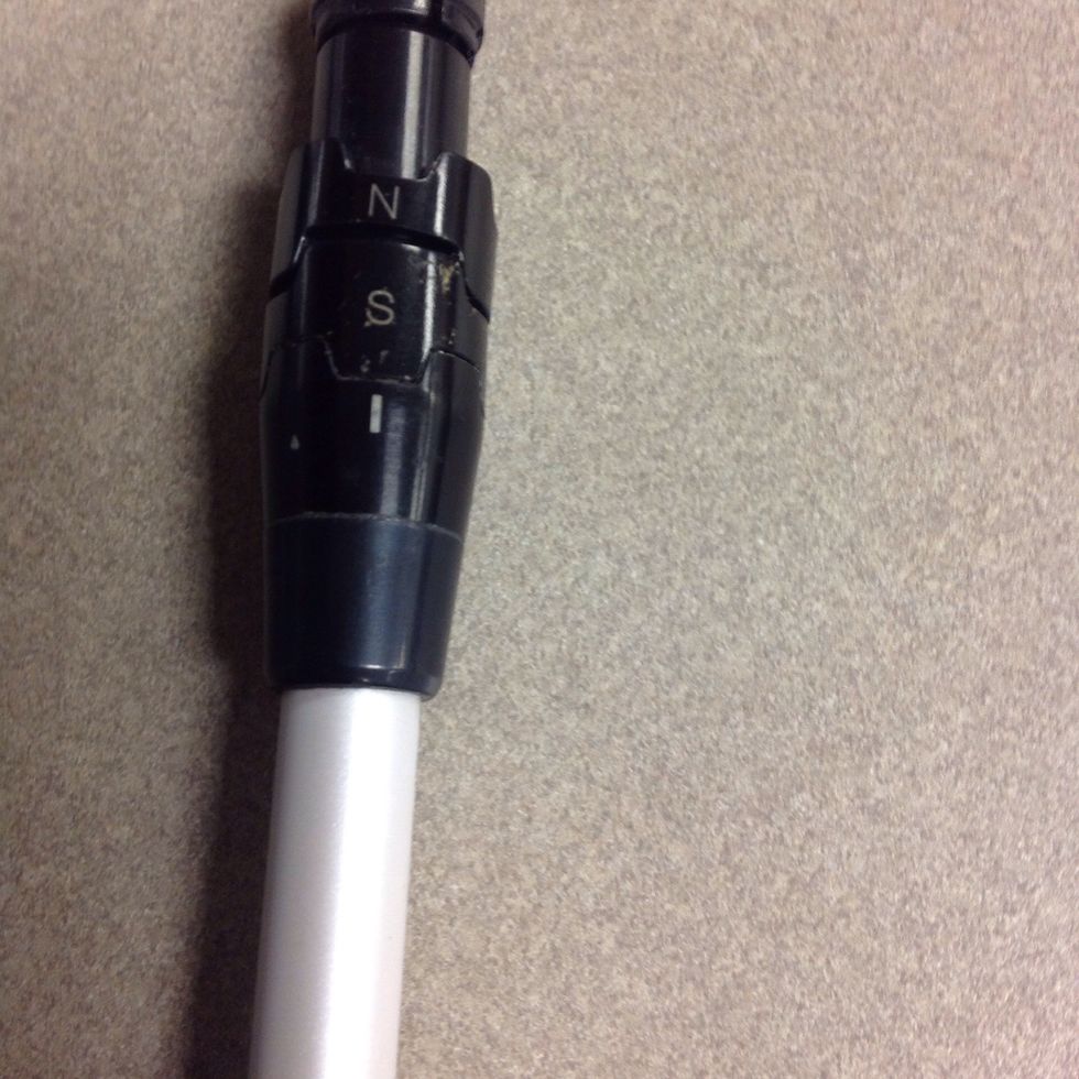 Adjust the pieces on the shaft to put it in its stated neutral setting. (N stands for neutral; S stands for stated loft.)