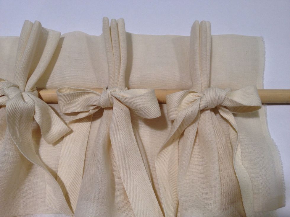 Adjust the pleats evenly in the rod and straighten the bows. Each panel should cover about 16" of space on either side of the rod.