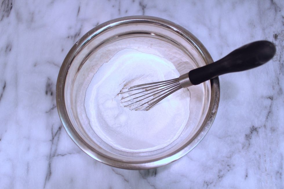 Aerate the sifted cake flour using a whisk.