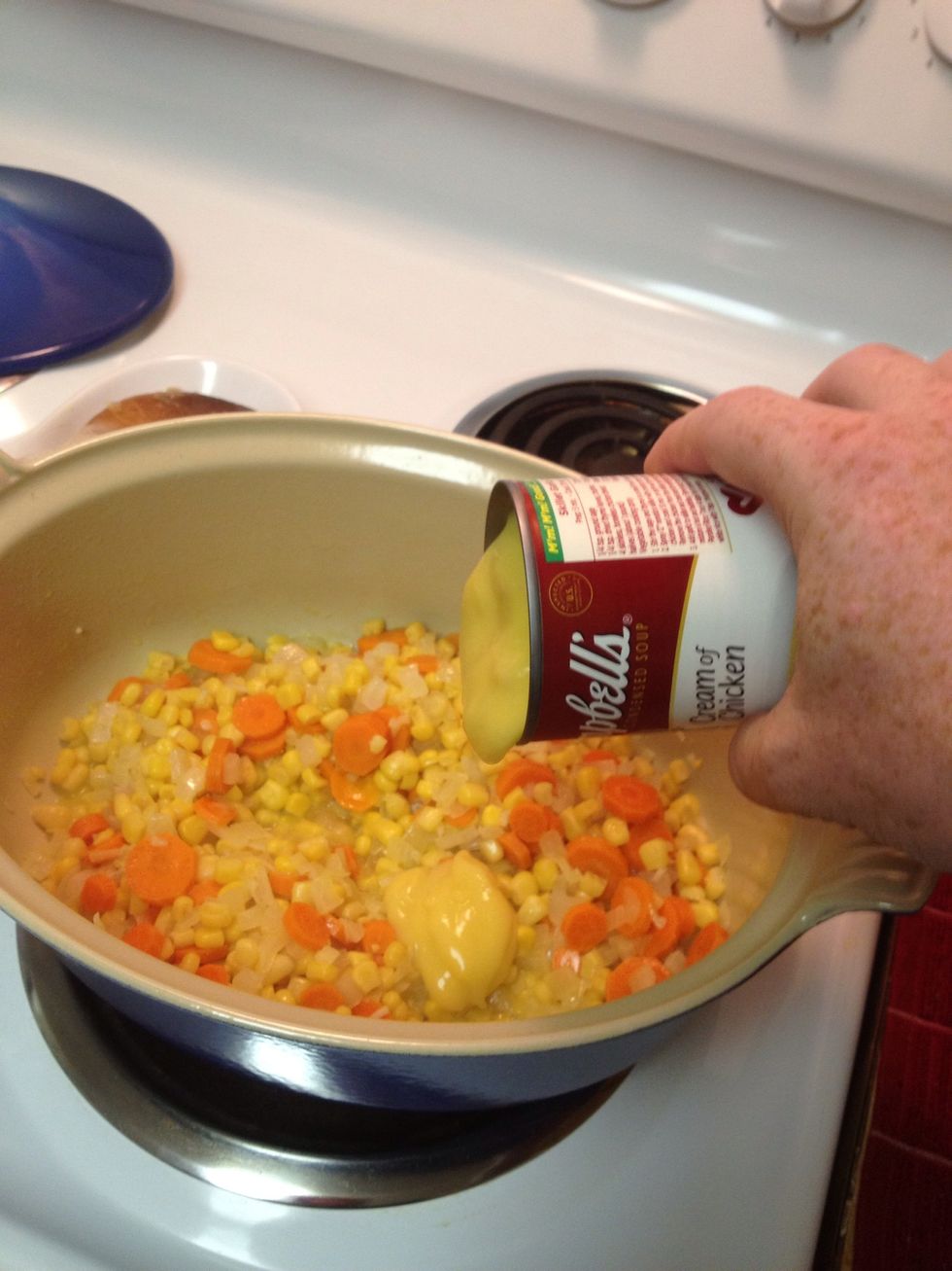 After 10 minutes add the corn and both cans of soup. Leave to heat through while preparing the chicken.