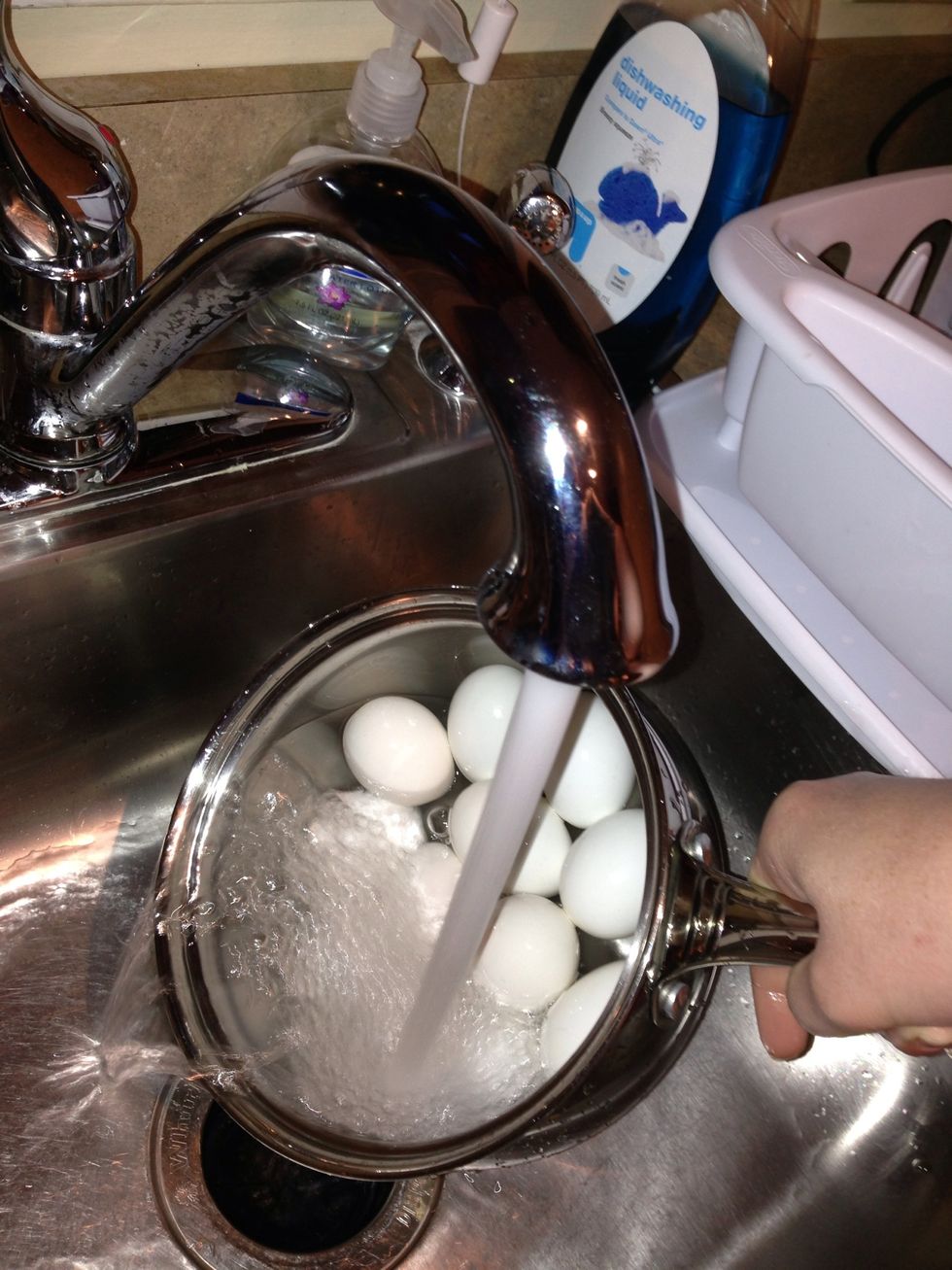After 10 minutes have passed, remove the pan from the stove. Dump out the hot water and replace it with cold water. You can even add ice cubes if you want. Let the eggs sit until they are cool.