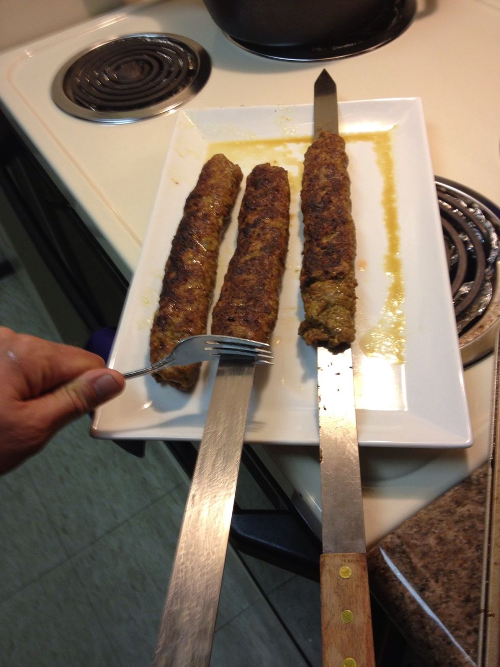 After 10 minutes remove kababs from grill and pull meat off skewer by using a fork to hold meat in place and slide out the skewer.