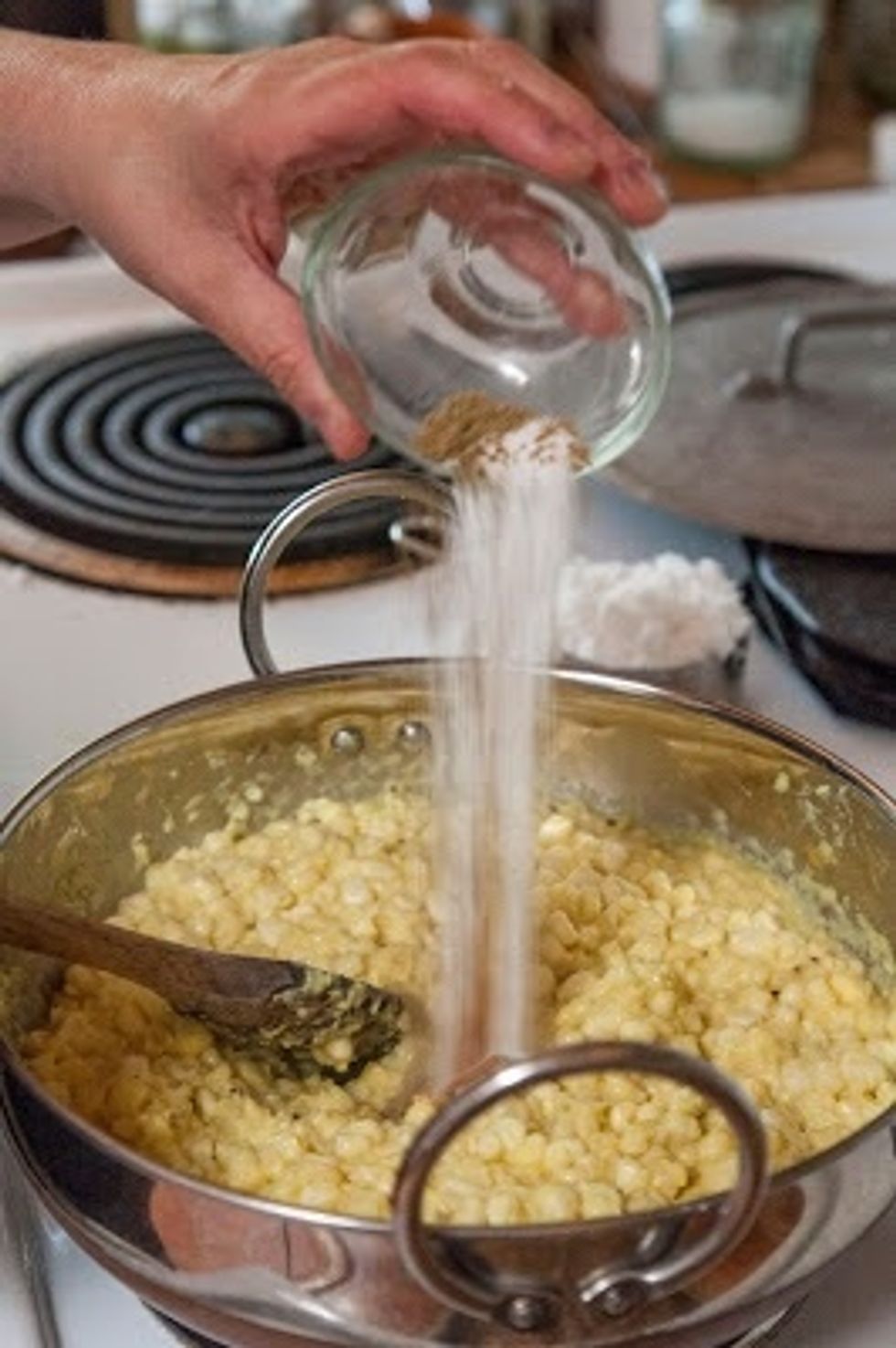 After 10 minutes, take off the cover and add in the sugar, salt, ground cumin, cayenne and lemon juice. Give everything a good stir, cover the pan again and cook for another 4 minutes or so.