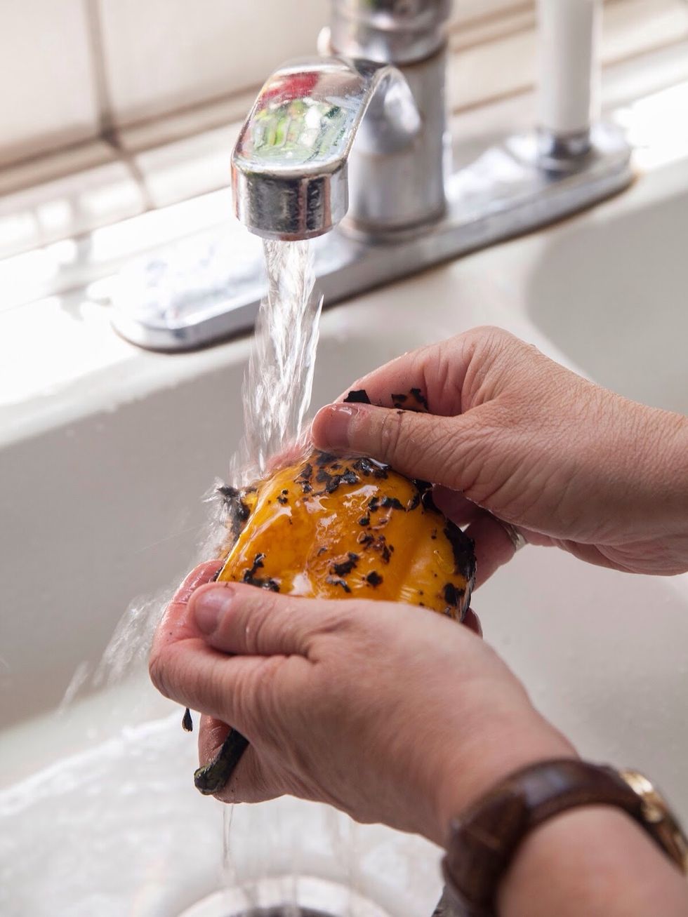 After 10 minutes take the pepper out and rinse it under cool running water, while rubbing the charred skin off.