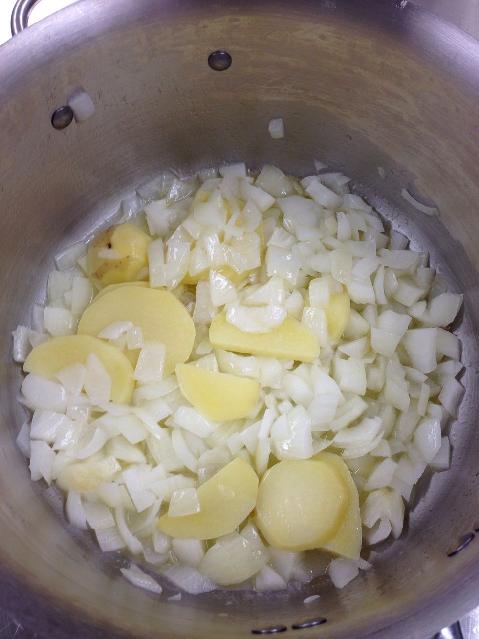 After 10 minutes, the onions and potato will be slightly cooked. Pull the pan out.
