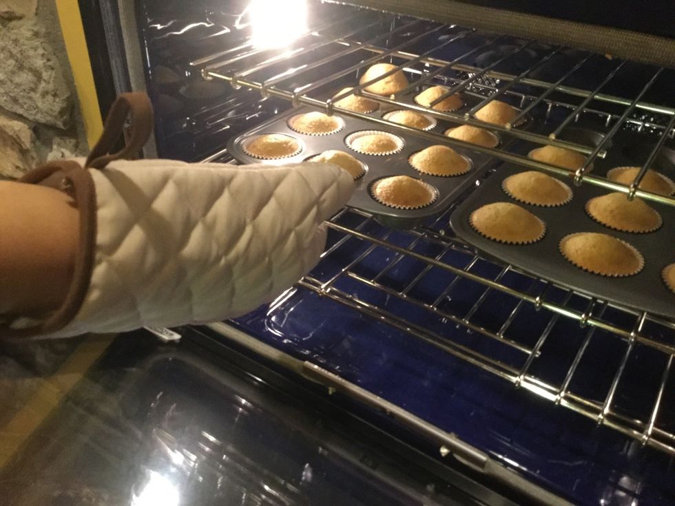After 14 minutes, take out both pans with mittens