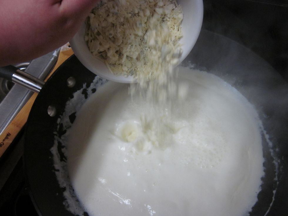 After 15 minutes, pour in the Gorgonzola and Parmesan cheeses. Stir until they are fully melted and mixed in.