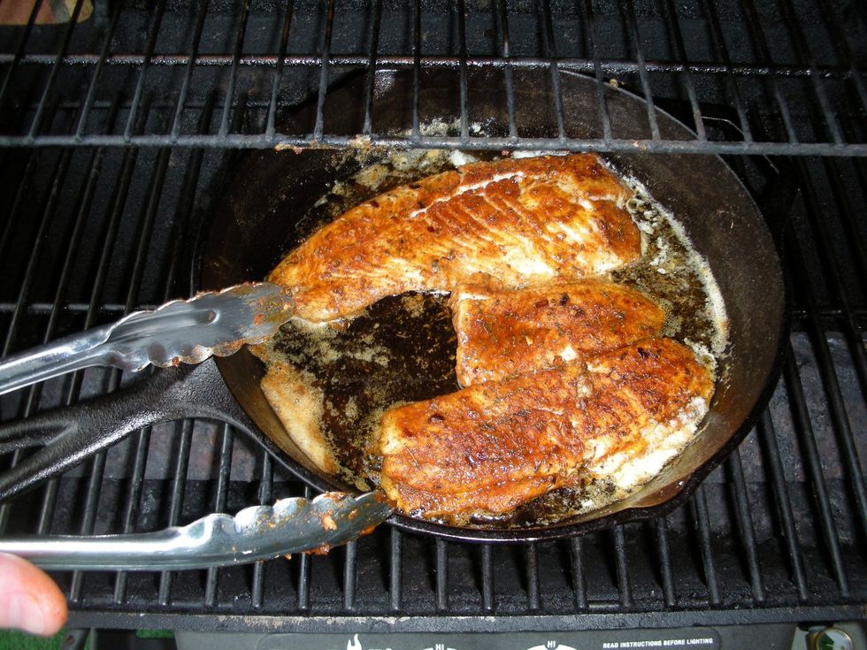After 2-3 minutes, depending on the exact size of the fillets, flip with tongs.