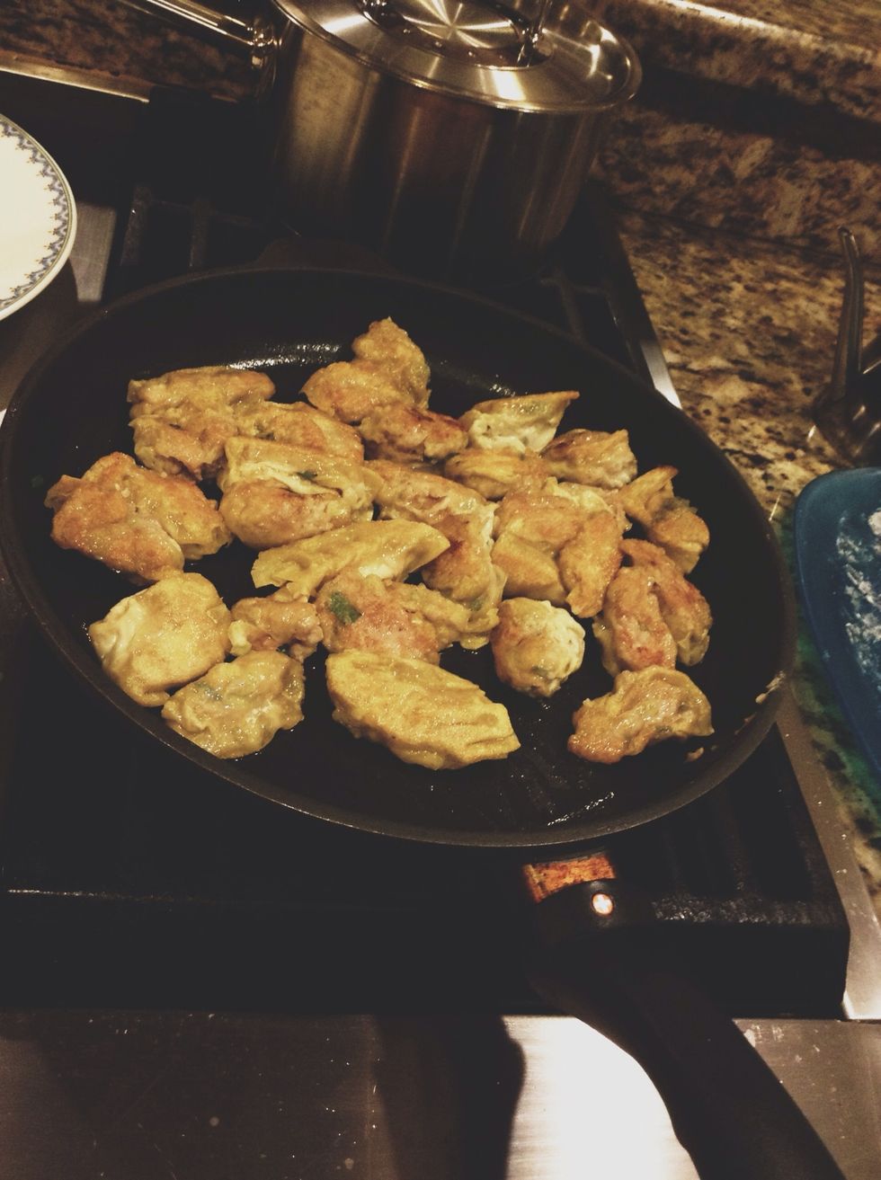 After 2-3 minutes, take off the tinfoil and cook the dumplings until they are crispy.